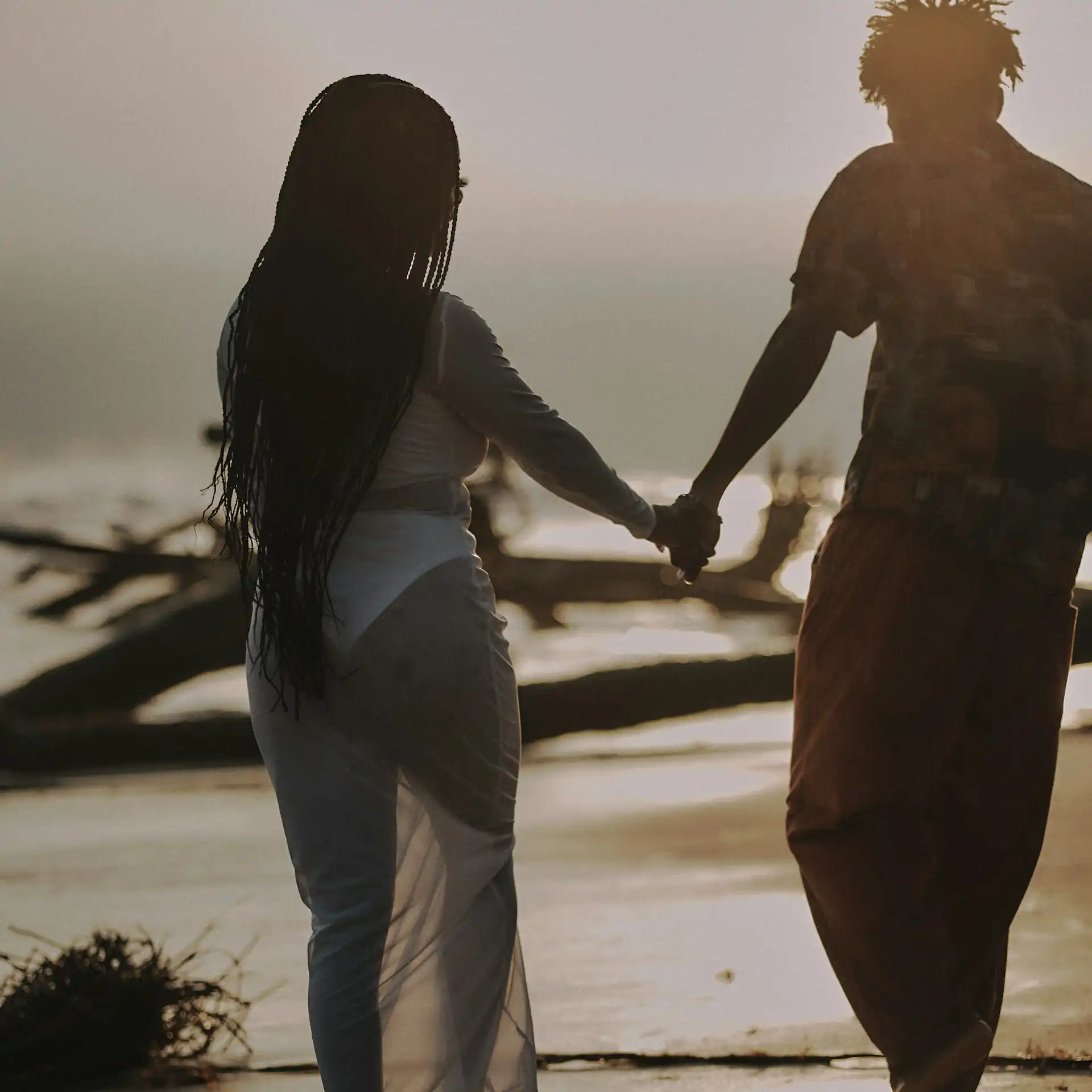 Couple walking hand in hand on Lafiaji Beach in Lekki, Lagos,